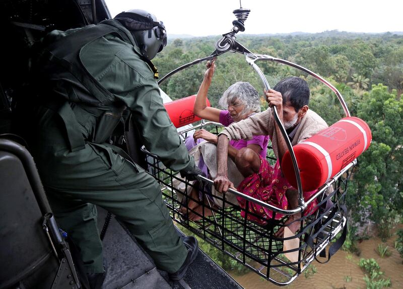 Indian Navy soldiers airlift residents during a rescue operation. Reuters