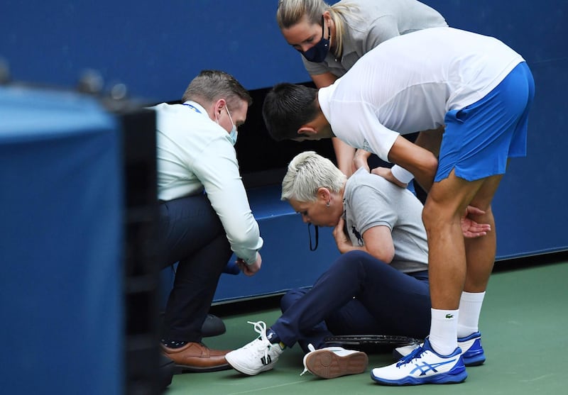 Novak Djokovic checks on the line judge. Reuters