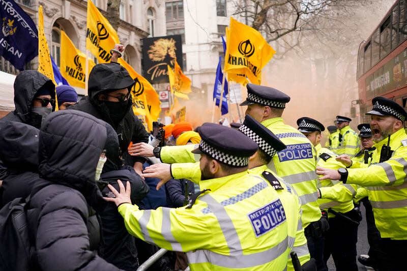 Police officers push back protestors of the Khalistan movement during a demonstration outside of the Indian High Commission in London on Wednesday. AP
