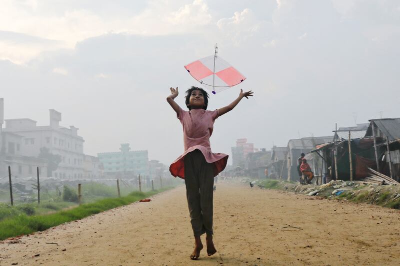 A girl flies a kite in the afternoon in Dhaka, Bangladesh. Reuters
