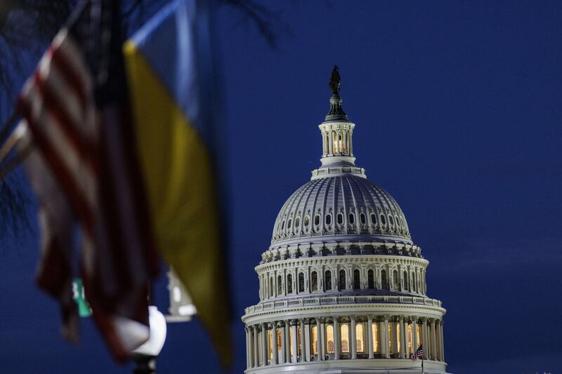 The US Capitol building can be seen past American and Ukrainian flags that were hung on the light posts lining Pennsylvania Avenue on Tuesday night. AFP