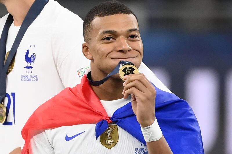 Kylian Mbappe celebrates with his medal. AFP