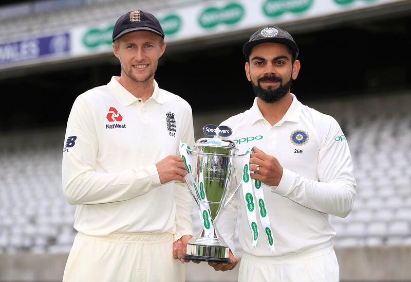 England captain Joe Root, left, and India captain Virat Kohli hold the Test match trophy during a media event at Edgbaston, Birmingham, England, Tuesday July 31, 2018. (Mike Egerton/PA via AP)