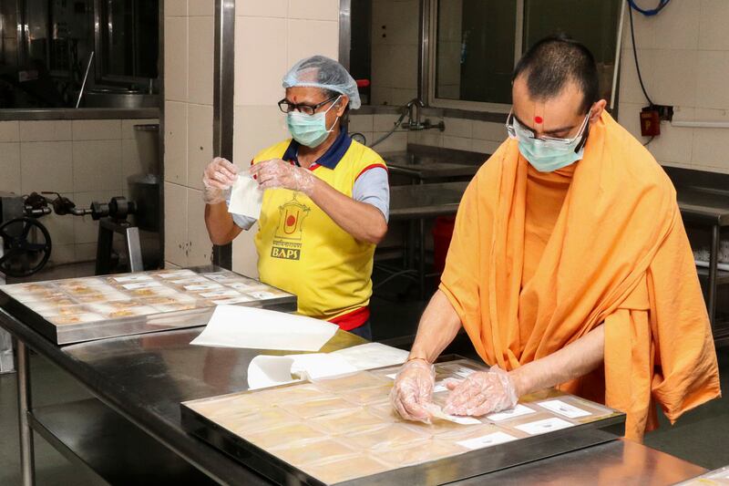 Food is packed by volunteers and priests from the Baps Swaminarayan Sanstha in Delhi for Covid-19 patients.