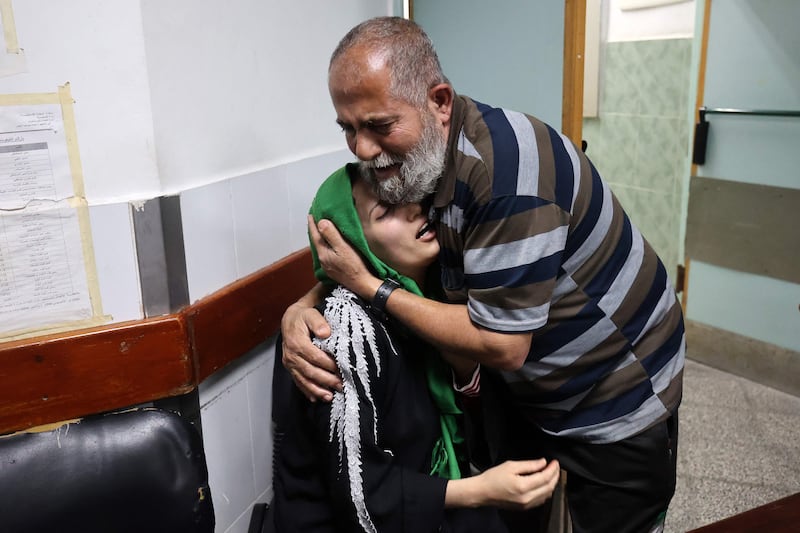 Relatives of Palestinian Islamic Jihad leader Jihad Ghannam, who was killed in the strikes, mourn at Al Najjar hospital in the Rafah refugee camp. AFP