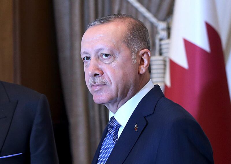 Turkey's President Recep Tayyip Erdogan, as he shakes hands with Qatar's Emir Sheikh Tamim bin Hamad Al Thani prior to their talks at the Presidential Palace in Ankara, Turkey, Wednesday, Aug. 15, 2018. Turkey said Wednesday it is increasing tariffs on some U.S. products like cars, alcohol, and coal _ a move that is unlikely to have much economic impact but highlights the deteriorating relations with the U.S. in a feud that has already helped trigger a currency crisis. (Presidential Press Service via AP, Pool)