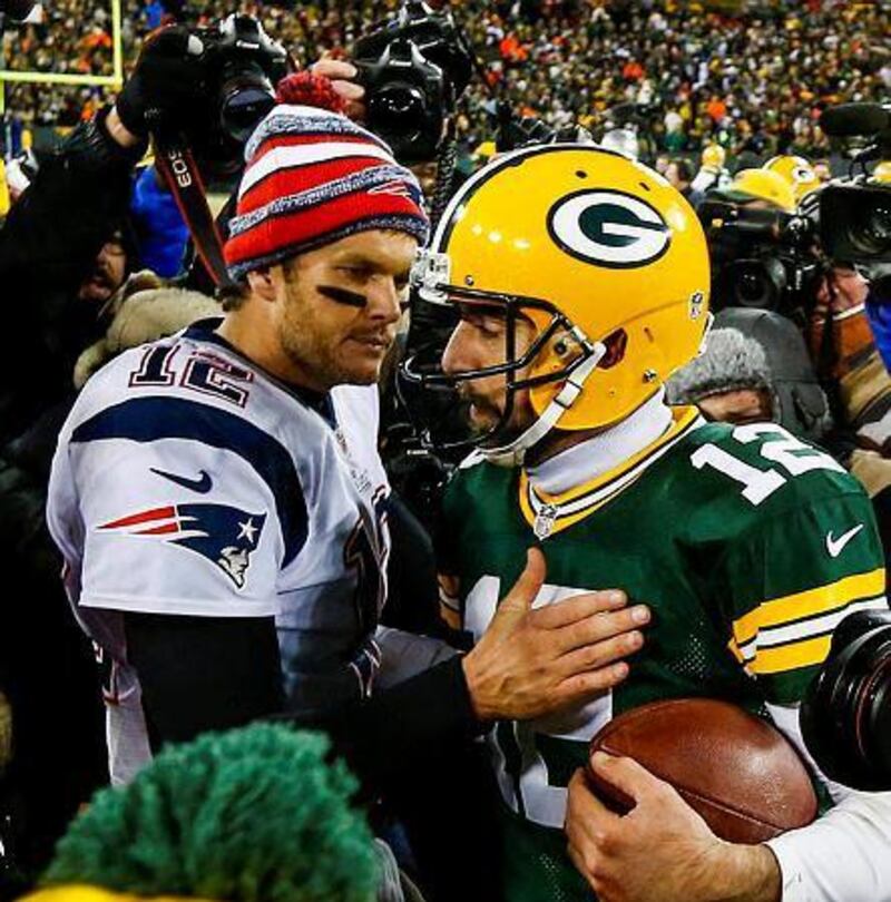 New England Patriots quarterback Tom Brady, left, and Green Bay Packers quarterback Aaron Rodgers come together after the final play in the second half of their American Football game at Lambeau Field in Green Bay, Wisconsin, USA, 30 November 2014. The Packers defeated the Patriots. EPA/TANNEN MAURY