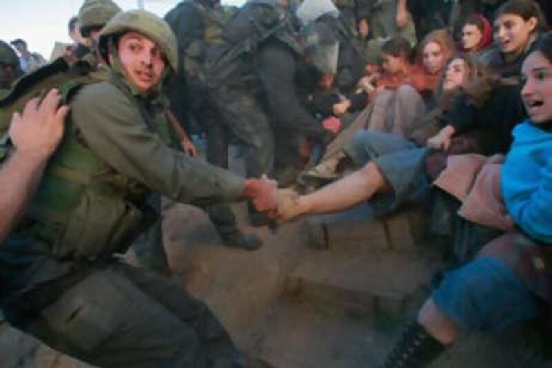 Israeli police struggle with right-wing women settlers as they evacuate Jewish extremists from a disputed house in Hebron on Dec 4 2008.