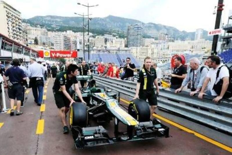 Caterham mechanics wheel one of their cars down the pit lane yesterday on the unmistakably tight Circuit de Monaco ahead of Sunday’s race.