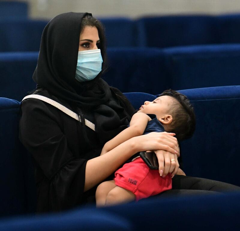 epa08523410 An Iraqi woman wears a protective mask as she waits to board her flight at Baghdad international Airport in Baghdad, Iraq, 02 July 2020. Iraqi Airways has recently reopen some flights to Turkey and Lebanon, as well as increasing the flight frequency gradually to other states, with adherence to health protection measures amid the ongoing coronavirus COVID-19 pandemic.  EPA/MURTAJA LATEEF