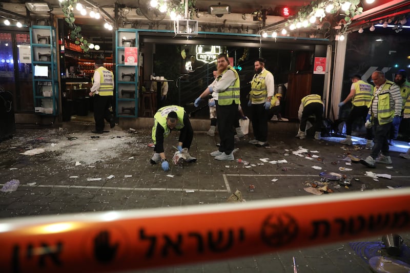 Israeli emergency teams clean up blood on the floor of a restaurant and bar on Dizengoff Street in Tel Aviv.  EPA