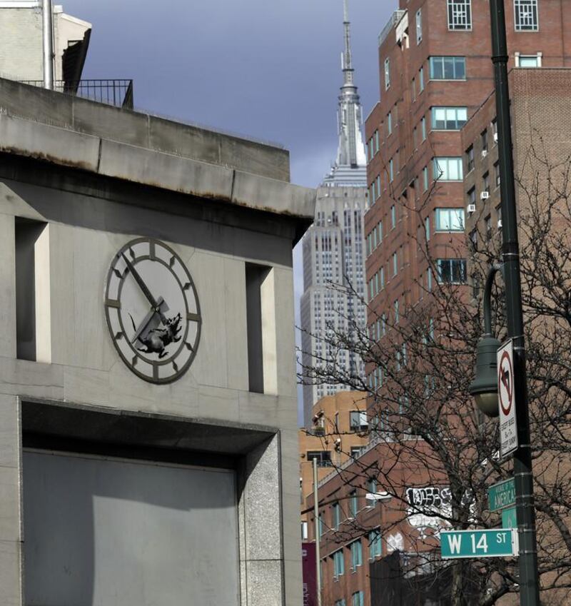 epa06606938 A new street art work by Banksy, the anonymous British street artist is of a rat In the inner portion of a clock above a closed former bank building on 14th Street and 6th Avenue in New York City, USA, 15 March 2018.  EPA-EFE/JASON SZENES