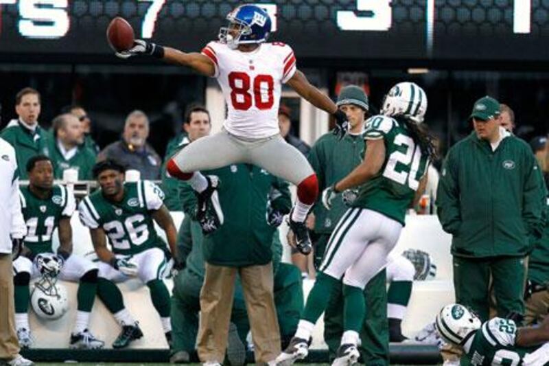 Victor Cruz, centre, set two franchise receiving records for the New York Giants during their game against the New York Jets.
