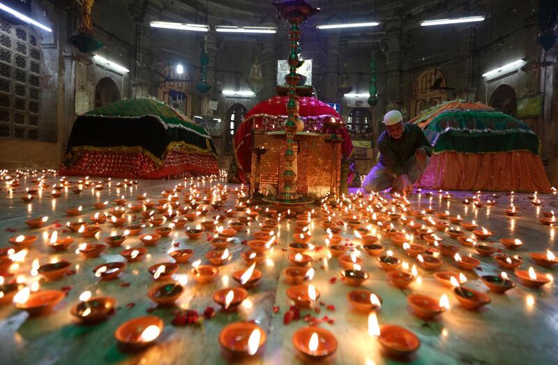 A man lights lamps before offering prayers for the protection against Covid19 at Badshah no Hajiro or King's Mausoleum in Ahmedabad, India. AP Photo