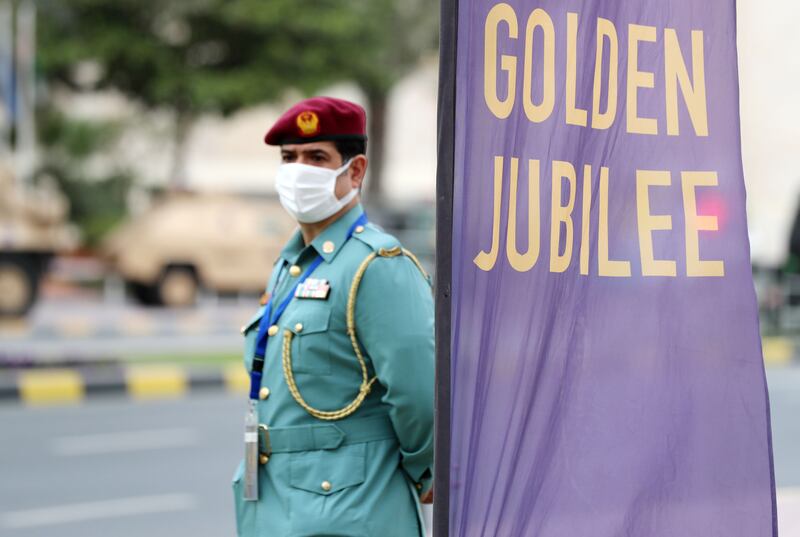 An officer stands by a Golden Jubilee banner.