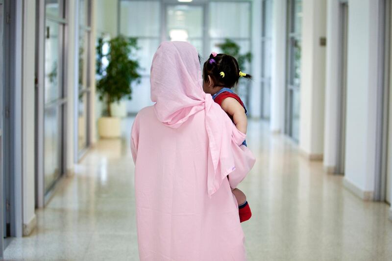 Dubai, Mar 14, 2012 --  KGR, a 34-year-old Filipina woman, holds her 10-month old baby, AH, who was born within the jail. Children of female prisoners live in-house with their mothers and attend school within the Women's Prison Department at the Dubai Central Jail, March 14, 2012.  (Sarah Dea/ The National)