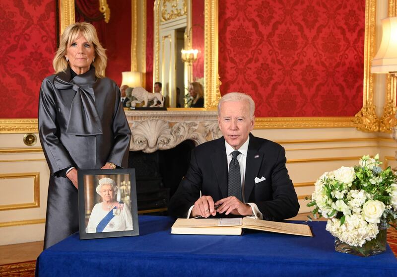 US President Joe Biden, accompanied by first lady Jill Biden, signs a book of condolence at Lancaster House in London following the death of Queen Elizabeth II. AFP
