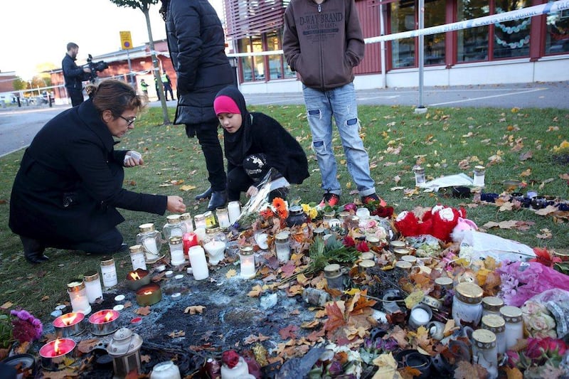 People light candles outside Kronan school in Trollhattan, Sweden. Adam Ihse / TT News Agency / Reuters