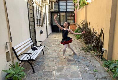 Paz Schattenhofer, 11, who participates in an international dance competition that encourages people to dance from home, as most theatres are closed due to the coronavirus disease (COVID-19) outbreak, poses for a photograph in Buenos Aires, Argentina August 24, 2020. Picture taken August 24, 2020. REUTERS/Horacio Soria