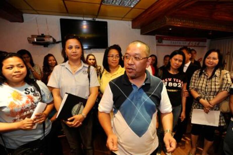 Alan Bacason(C), newly elected President of the Filipino Community for Dubai and the Northern Emirates (Filcom Dubai-NE), standing with other elected officials speaks to a gathering of Filipinos after election held on Friday, Sept. 23, 2011 in Dubai, United Arab Emirates. Photo: Charles Crowell for The National