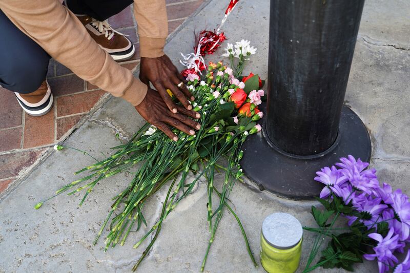 A person lays down flowers as members of the community hold a prayer vigil near the scene of the shooting. Reuters