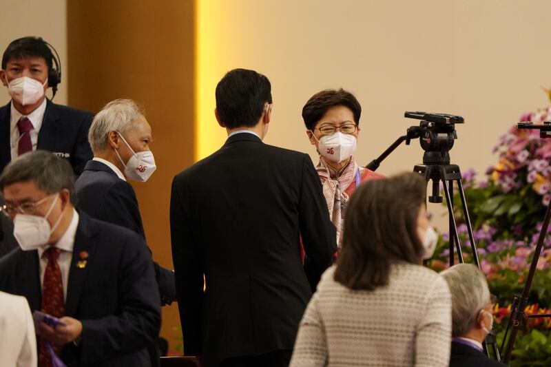 Former chief executive Ms Lam, right, and her husband Lam Siu-por, left, at the swearing-in ceremony. Bloomberg