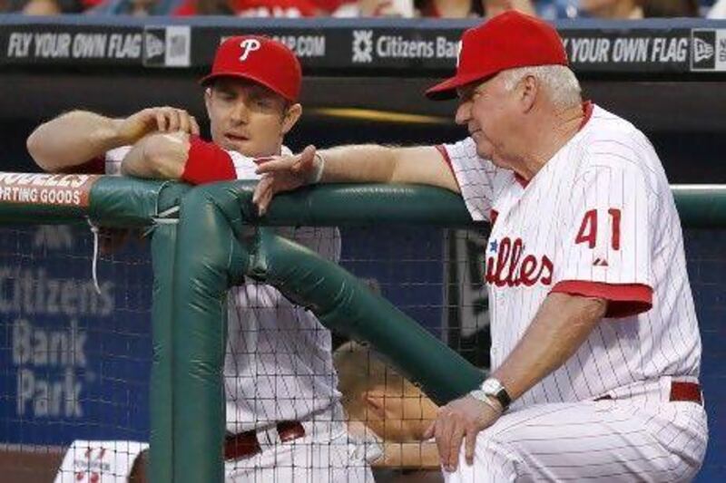 Philadelphia Phillies manager Charlie Manuel, right, talks with Chase Utley who has a balky knee.