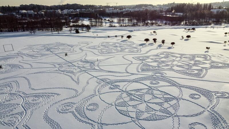 An aerial photograph shows a snow drawing made entirely of footprints on a golf course outside the Finnish capital Helsinki, in Espoo.  The artwork is the brainchild of IT consultant Janne Pyykkö. AFP