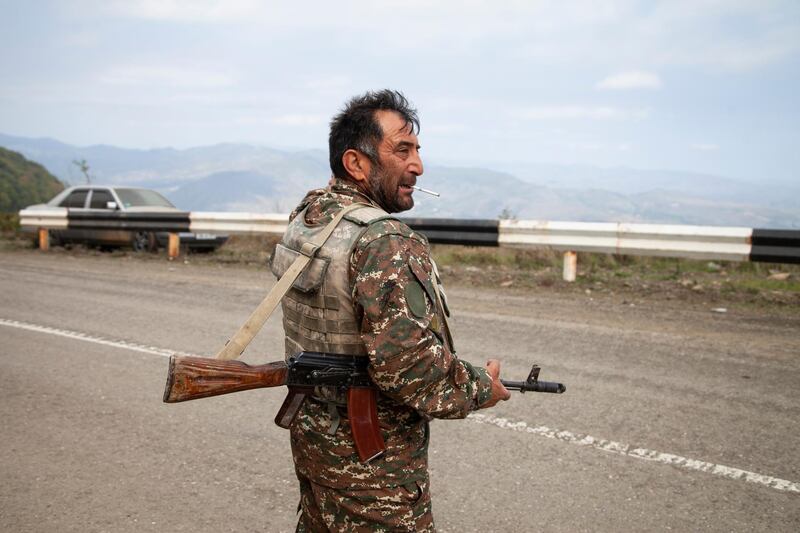 Nagorno-Karabakh militia soldier Kamo Naira holds his Kalashnikov during a military conflict near Hadrut, the separatist region of Nagorno-Karabakh, Saturday, Oct. 10, 2020. Armenia and Azerbaijan on Monday accused each other of attacks over the separatist territory of Nagorno-Karabakh despite a cease-fire deal brokered by Russia to try to end the worst outbreak of hostilities in the region in decades. (AP Photo)