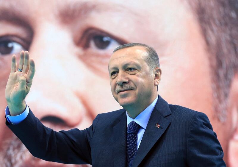 Turkey's President Recep Tayyip Erdogan waves to supporters of his ruling Justice and Development Party (AKP), at a rally in Elazig, eastern Turkey, Saturday, Jan. 13, 2018. Erdogan has said Turkey will oust Kurdish militants from Afrin, northern Syria, as the military shelled the area from across the border. Turkey considers the YPG a terror group and an extension of the Kurdish insurgency within its own borders. (Pool Photo via AP)