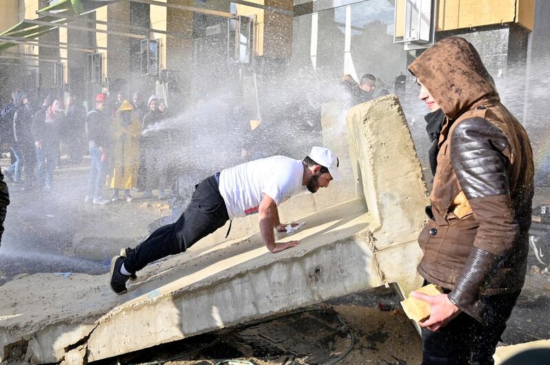 Lebanese riot police spray water cannons to disperse anti-government protestors on the road leading to the parliament building in downtown Beirut, Lebanon.  EPA