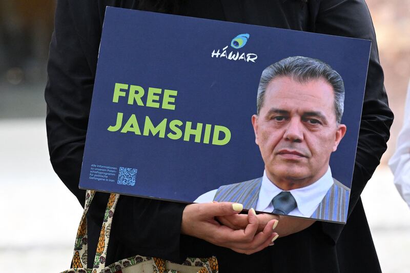 A demonstrator holds a picture of Iranian-German Jamshid Sharmahd in front of the German Foreign Ministry in Berlin on July 31. AFP