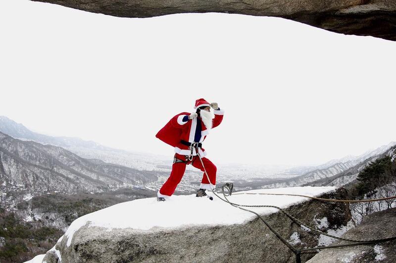 South Korea’s Bukhan San Mountain Rescue Police captain Kim Chang-Gon, wearing a Santa Claus costume, while rock-climbing during an event marking the Christmas holiday season on Buckhan mountain near Seoul, South Korea. Jeon Heon-Kyun / EPA