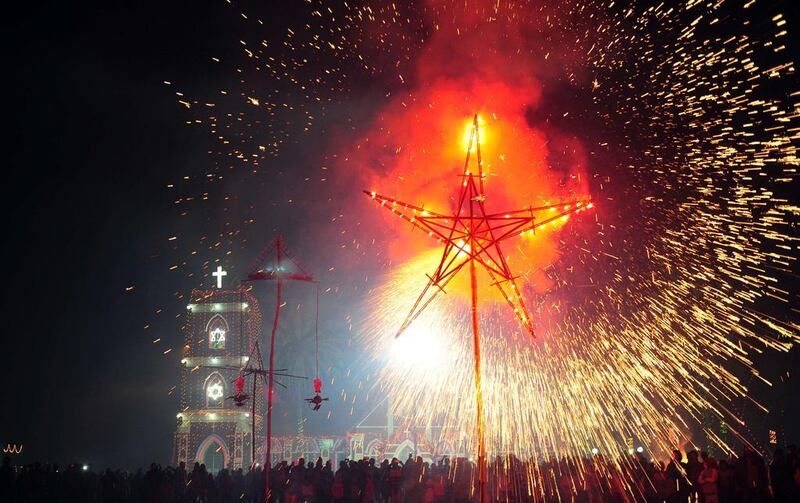 Indian Christian devotees watch a fireworks display outside St. Peter's Church in Allahabad, India.  Sanjay Kanoiia / AFP