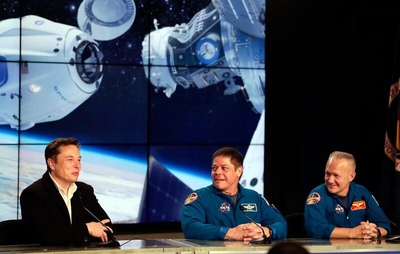 Elon Musk, CEO of SpaceX, speaks as NASA astronauts Bob Behnken and Doug Hurley listen during a news conference after the SpaceX Falcon 9 Demo-1 launch. AP