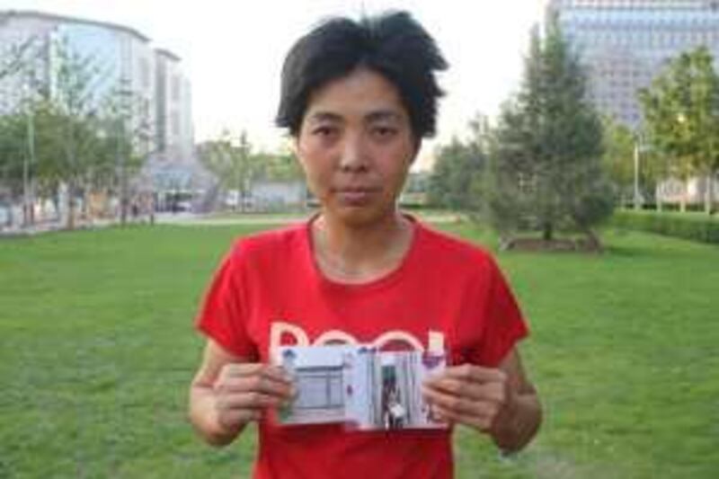 BEIJING, CHINA, MAY 2009: Jin Hanyan, 34, holds up photos of the illegal detention centre - black house - in Beijing where she was incarcerated. Daniel Vincent for The National