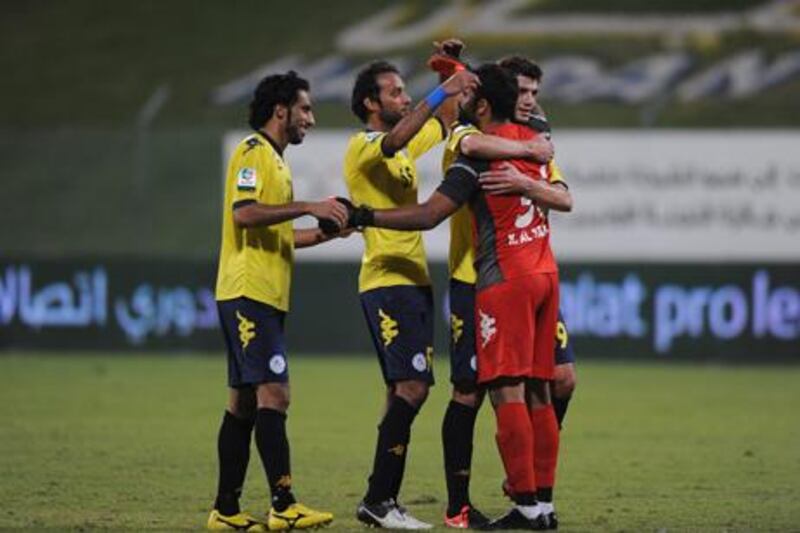 Al Dhafra players celebrate after their win over Al Nasr.