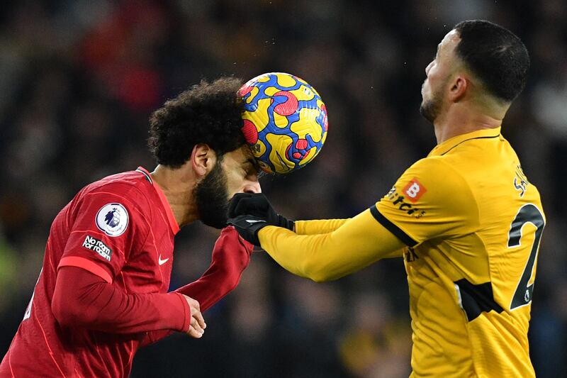 Liverpool attackerMohamed Salah heads the ball. AFP
