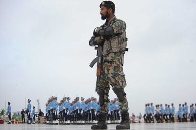 A Pakistani soldier stands guard as Pakistan Air Force soldiers attend a ceremony in Karachi. EPA