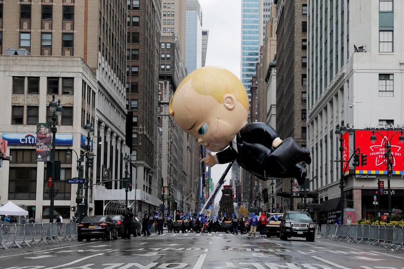 Assistants carry 'The Boss Baby' balloon during the 94th Macy's Thanksgiving Day Parade in Manhattan, New York City. Reuters