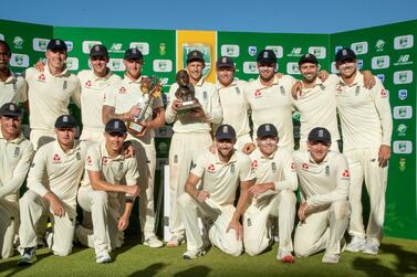 England players pose for photographers after receiving their trophy at the end of day four of the fourth cricket test match between South Africa and England at the Wanderers stadium in Johannesburg, South Africa, Monday, Jan. 27, 2020. England beat South Africa by 191 runs to win 3-1 series. (AP Photo/Themba Hadebe)