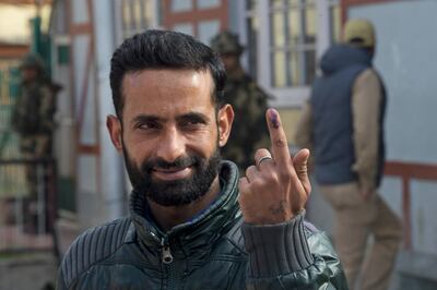 A Kashmiri man displays the indelible ink mark on his index finger after casting his vote, outside a polling booth during the second phase of India's general elections, in Srinagar, Indian controlled Kashmir, Thursday, April 18, 2019. Kashmiri separatist leaders who challenge India's sovereignty over the disputed region have called for a boycott of the vote. Most polling stations in Srinagar and Budgam areas of Kashmir looked deserted in the morning with more armed police, paramilitary soldiers and election staff present than voters. (AP Photo/ Dar Yasin)