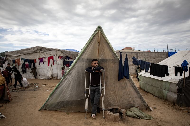 An injured Palestinian man outside his tent in Rafah camp, southern Gaza Strip. EPA