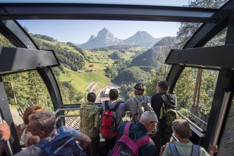 Tourists enjoy a ride on the Stoos Bahn, the steepest funicular railway in the world, inaugurated six months ago, in Stoos, Switzerland. Urs Flueeler / EPA