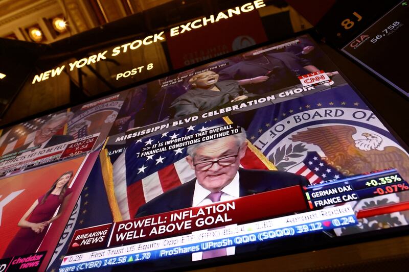 Federal Reserve chairman Jerome Powell appears on a screen on the trading floor of the New York Stock Exchange. The US central bank on Wednesday delivered a smaller interest rate increase in its historic fight against inflation, while also indicating that more increases are to come. Reuters