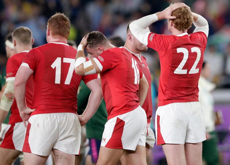 Wales' Rhys Patchell, right, and Elliot Dee, center, hold their heads after losing to South Africa during the Rugby World Cup semifinal at International Yokohama Stadium in Yokohama, Japan.  AP