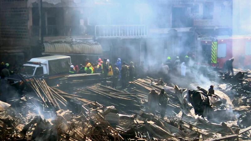 Emergency services work at the scene after a fire swept through a marketplace in Nairobi, Kenya, Thursday June 28, 2018.  Authorities report that several people are known to have died and about 70 are receiving hospital treatment, with rescue teams still searching for more bodies and survivors in the market. (AP Photo)