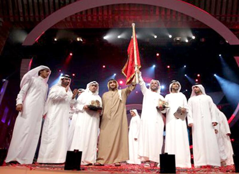 Rashid Ahmed Al Rumaithi, in brown, won the fifth edition of Million's Poet in 2012. Courtesy Million's Poet 