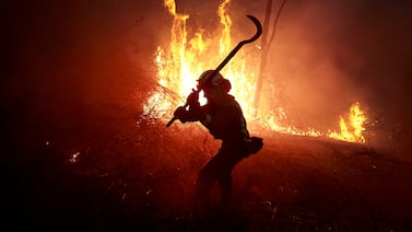 A firefighter tackles a forest blaze during an outbreak of wildfires in Peidrafita, Asturias, Spain. Reuters
