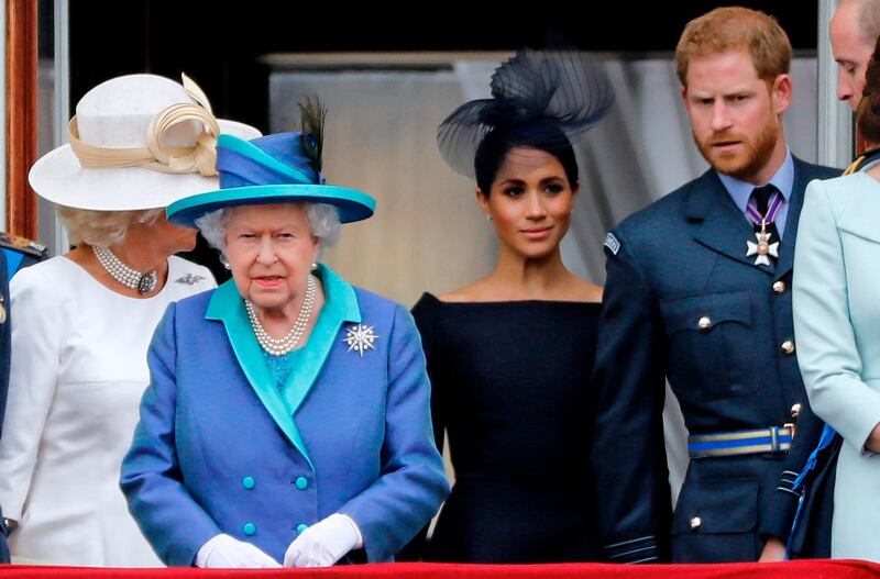 (FILES) In this file photo taken on July 10, 2018 (L-R) Britain's Camilla, Duchess of Cornwall, Britain's Queen Elizabeth II, Britain's Meghan, Duchess of Sussex, Britain's Prince Harry, Duke of Sussex, AND Britain's Prince William, Duke of Cambridge come onto the balcony of Buckingham Palace to watch a military fly-past to mark the centenary of the Royal Air Force (RAF). Britain's Prince Harry and his wife Meghan will step back as senior members of the royal family and spend more time in North America, the couple said in a shock announcement on January 8, 2020. The surprise news follows a turbulent year for the monarchy, with signs that the couple have increasingly struggled with the pressures of royal life and family rifts. "We intend to step back as 'senior' members of the royal family and work to become financially independent, while continuing to fully support Her Majesty The Queen," they said in a statement released by Buckingham Palace. / AFP / Tolga AKMEN
